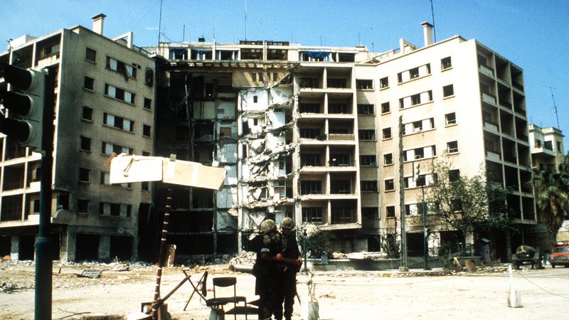 Two Marines stand in front of the US Embassy which was destroyed by a terrorist bomb attack in 1983