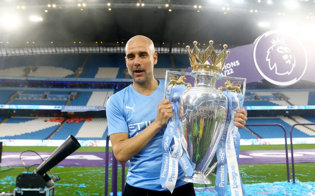 Pep Guardiola holds the Premier League trophy for the sixth time after Manchester City defeated Aston Villa