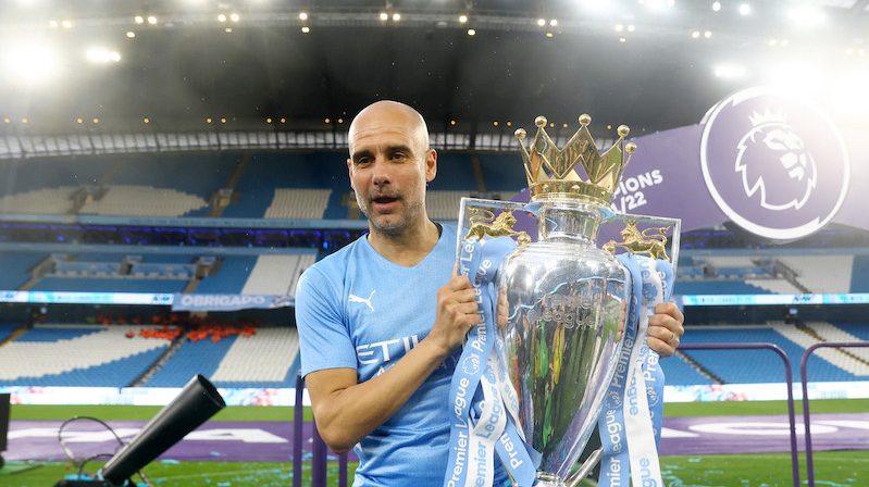 Pep Guardiola, the Manchester City manager, celebrates with the trophy after winning the Premier League last season