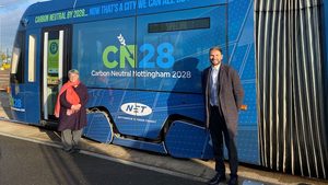 Councillor Sally Longford and Wayne Bexton, director of carbon reduction at Nottingham City Council, pose beside a Nottingham Express Transit tram