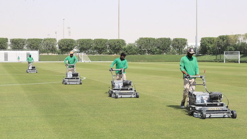 Ground staff work on a training pitch ahead of the Qatar World Cup