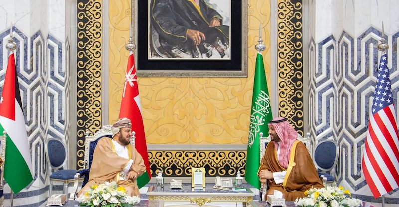 Saudi crown prince Mohammed bin Salman, right, speaks with Oman's deputy prime minister for international relations and affairs Asaad bin Tariq Al Said