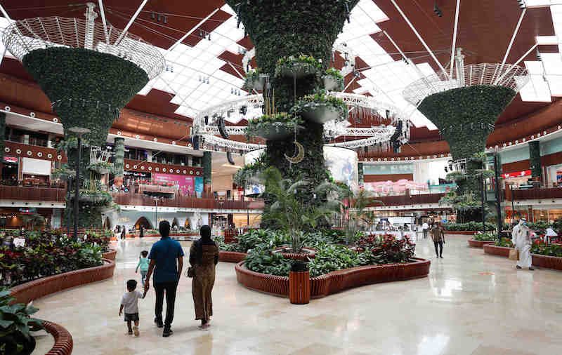 A family walks through the Mall of Qatar