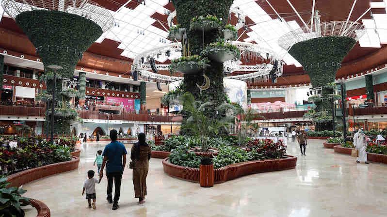 A family walks through the Mall of Qatar