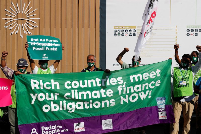 Activists demonstrate at the Sharm El Sheikh International Convention Centre during Cop27