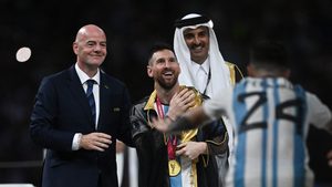 Lionel Messi accepts the World Cup trophy from the emir of Qatar Sheikh Tamim bin Hamad Al Thani and Fifa president Gianni Infantino after Argentina defeated France on penalties at the Lusail Stadium