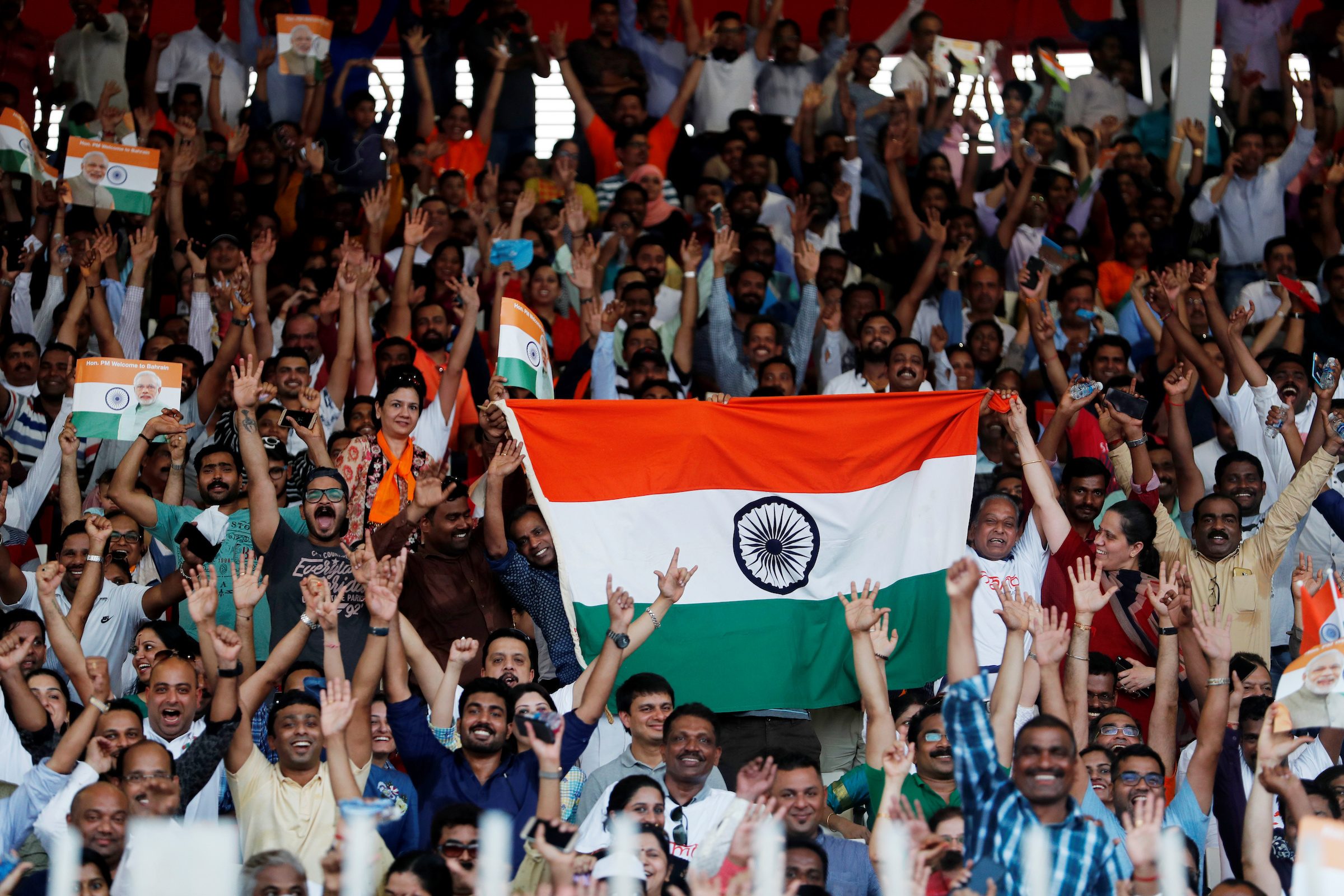 Indians in Bahrain wave flags as they wait for Narendra Modi, India's PM, at Bahrain National Stadium in Manama. More than half of Indian expats live in GCC states