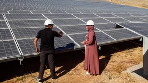 solar panels, woman, man, helmet