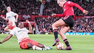Hawa Cissoko of West Ham slides in on Alessia Russo of Manchester United, giving away a penalty during the Womens Super League game at Old Trafford on March 25