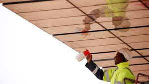 man cleaning solar panels