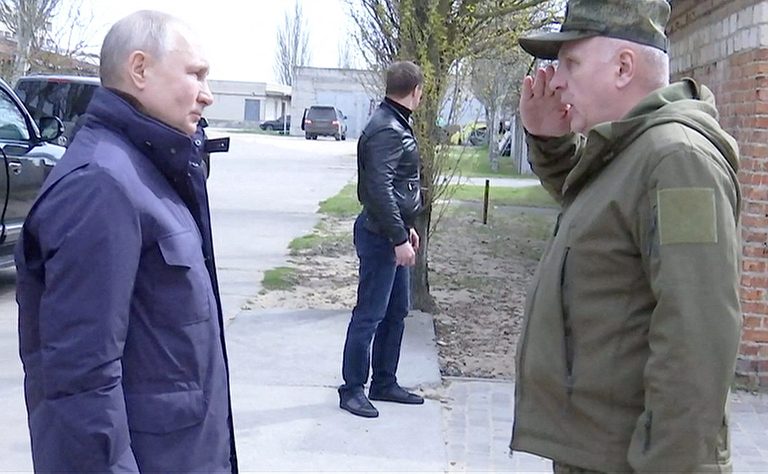 President Vladimir Putin greets a military officer in the Kherson region of Ukraine