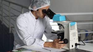 Lab worker with microscope
