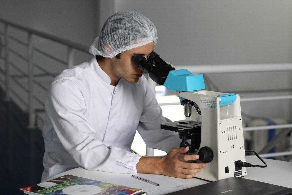 Lab worker with microscope
