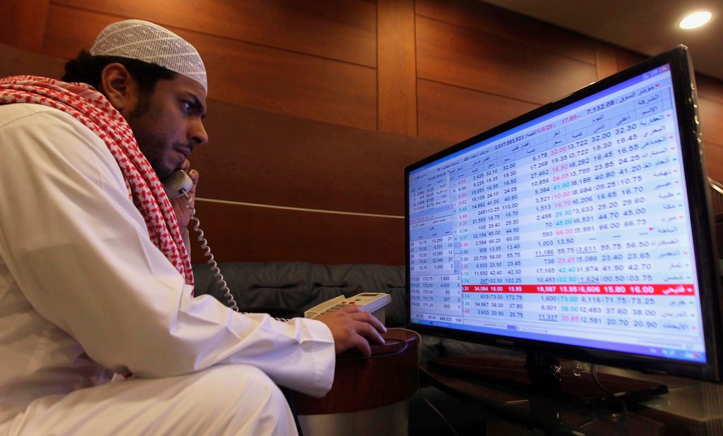 A trader monitors stocks at the Saudi stock market in Riyadh. Saudi banking stocks are slumping despite steady earnings