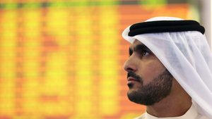 An Investor looks at the screen at the Dubai Financial Market in Dubai DFM