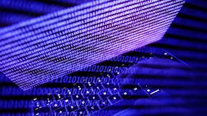 Binary code displayed on a laptop screen cybersecurity