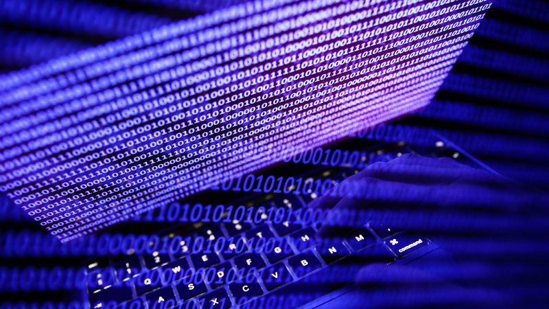 Binary code displayed on a laptop screen cybersecurity