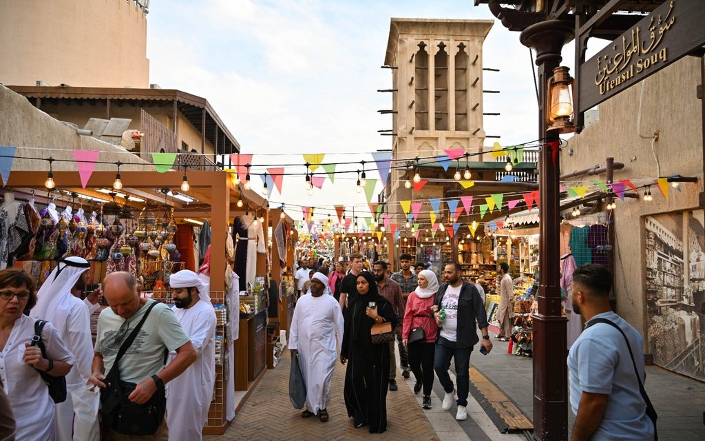 Visitors at a Dubai souq. The tourism sector's 'robust recovery' should help government-related entities to repay debt, said S&P