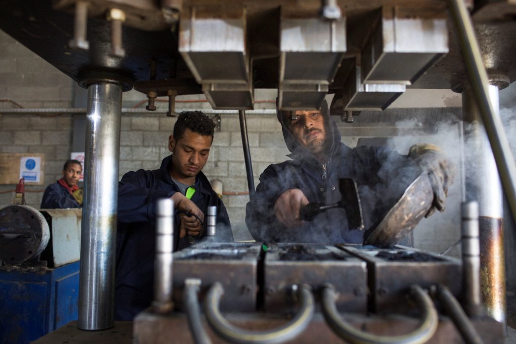 Workers at an Egyptian startup producing tiles from recycled materials. S&P's PMI for May reported a near-stabilisation in manufacturing