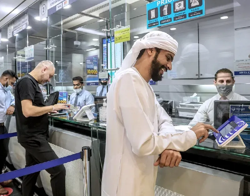 Customers at UAE remittance company Al Ansari. The revised pricing remains is in line with the UN's sustainable developmental goals