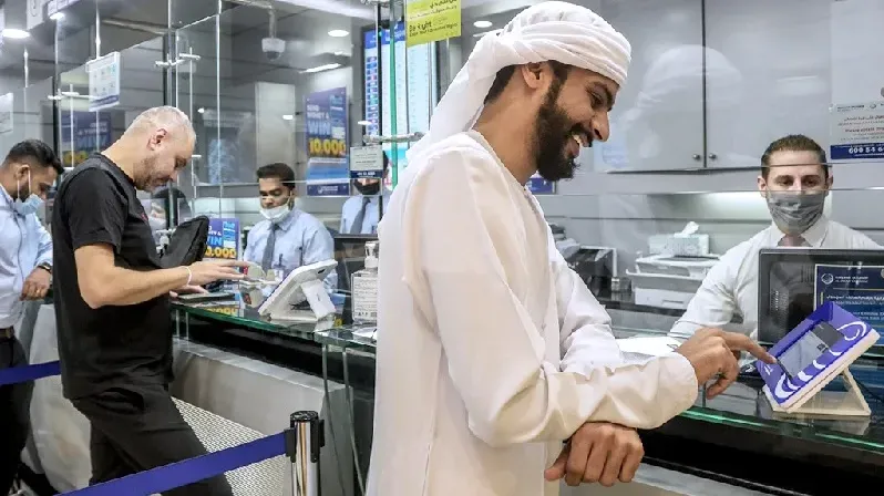 Customers at UAE remittance company Al Ansari. The revised pricing remains is in line with the UN's sustainable developmental goals