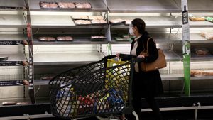 A shopper walks past near-empty shelves at a supermarket in Beirut, Lebanon