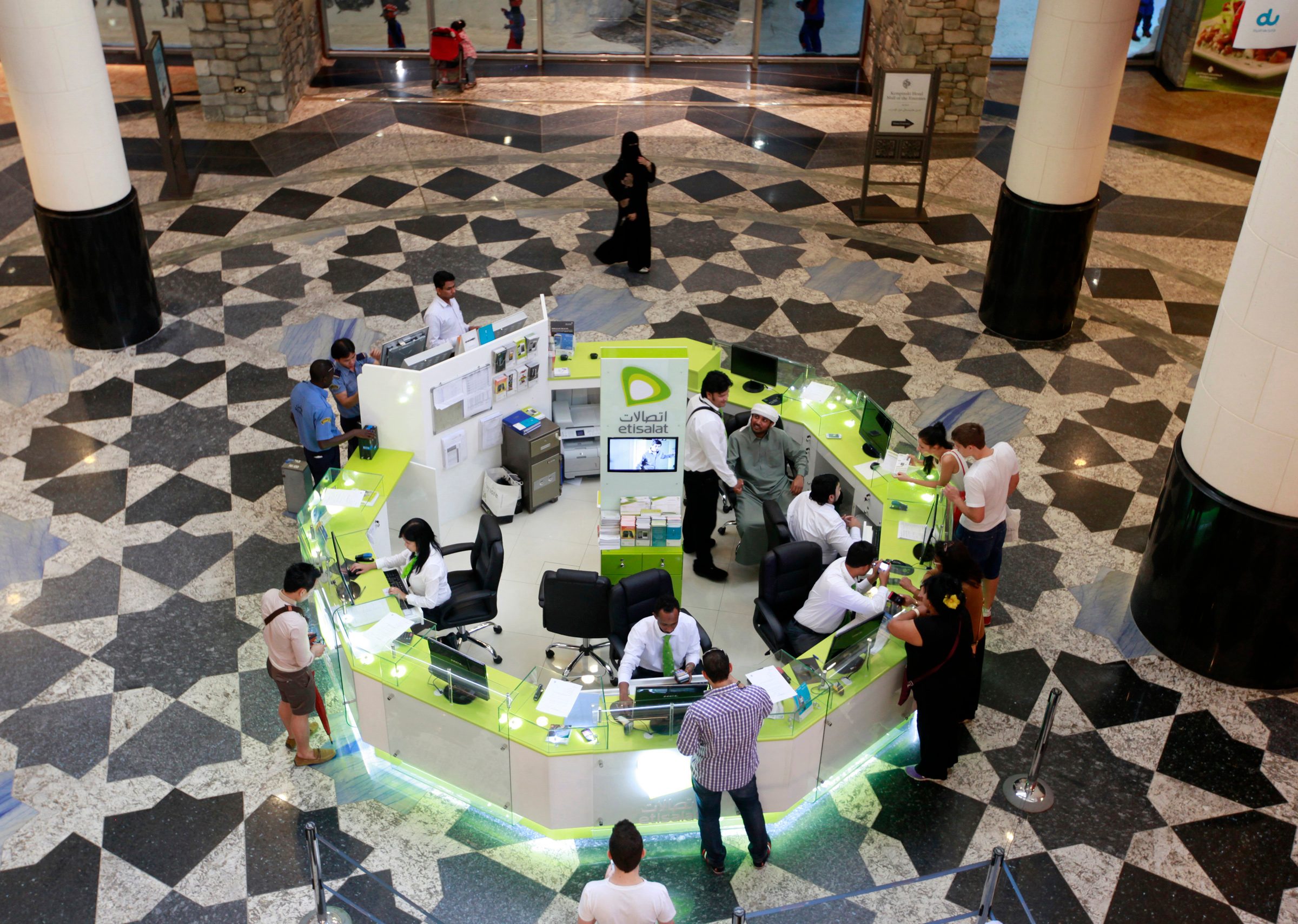 Customers queue at an Etisalat kiosk at a Dubai mall. The telecoms giant is in talks with Czech firm PPF Group