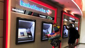 A man uses a Bank of America cash dispenser. The bank advised on two multibillion-dollar mergers in H1 2023