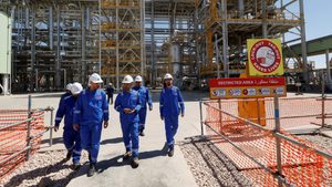 Workers at an oil refinery in Kerbala, central Iraq. Rising oil prices have helped the country to pay down debt