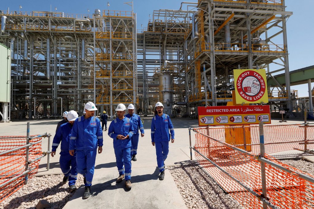 Workers at an oil refinery in Kerbala, central Iraq. Rising oil prices have helped the country to pay down debt
