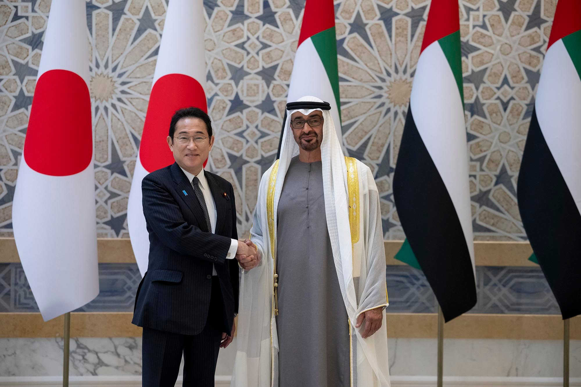 Japanese premier Fumio Kishida greets the UAE's president, Sheikh Mohamed bin Zayed, in Abu Dhabi on Monday