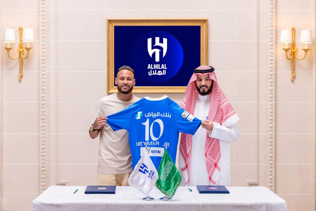Al Hilal's new signing Neymar poses with club president Fahd bin Saad Al-Nafel
