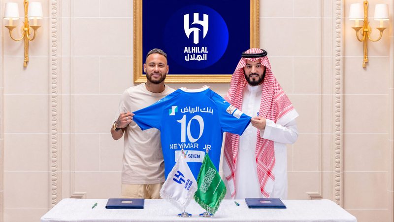 Al Hilal's new signing Neymar poses with club president Fahd bin Saad Al-Nafel