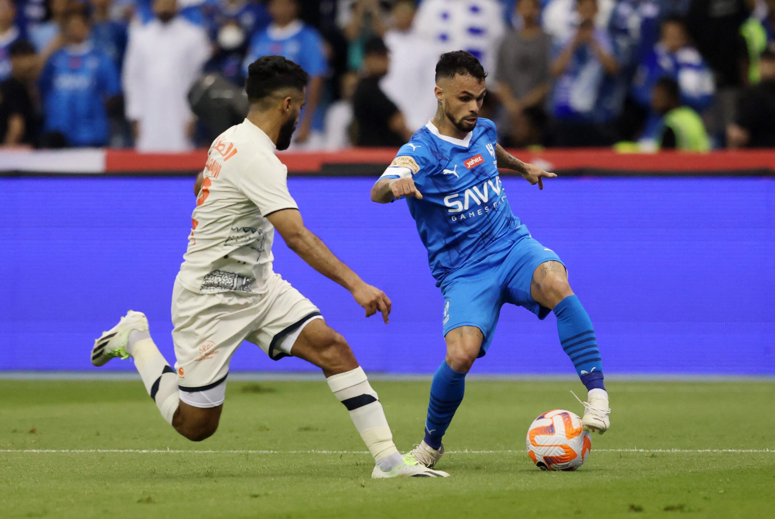 Saudi Pro League footbal - Al-Feiha's Mohammed Al Baqawi in action with Al-Hilal's Michael