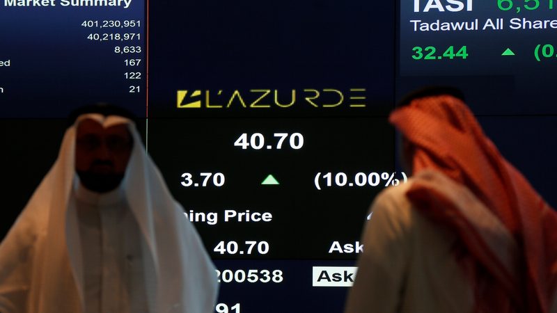 Traders monitor a screen showing stock information at the Tadawul in Riyadh