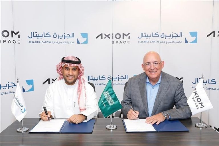 Aljazira Capital CEO Naif AlMesned and Axiom Space CEO Michael Suffredini signing the funding round documents