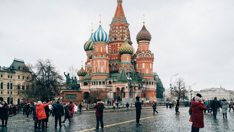 Tourists and residents in Red Square, Moscow, Russia - St Basil's Cathedral is visible