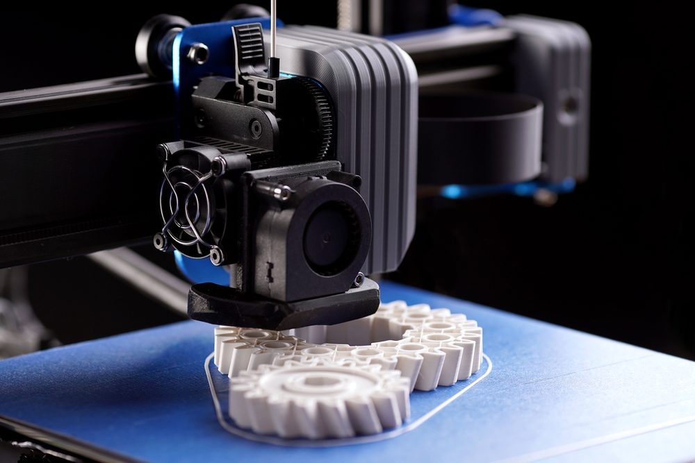 3D printing machine creating cogs