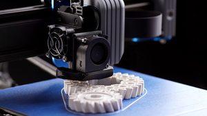 3D printing machine creating cogs