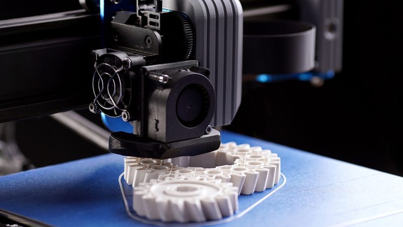 3D printing machine creating cogs