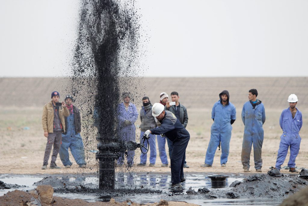 Iraqi oil workers at the Al Tuba field in Basra. The IEA believes the rise of competitive alternatives to fossil fuels will reverse demand