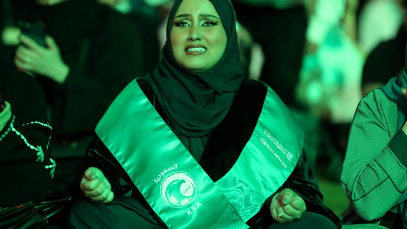 A fan watches the Saudi national side take on Mexico in the 2022 World Cup. Thousands of Saudi Arabians visited Qatar for matches