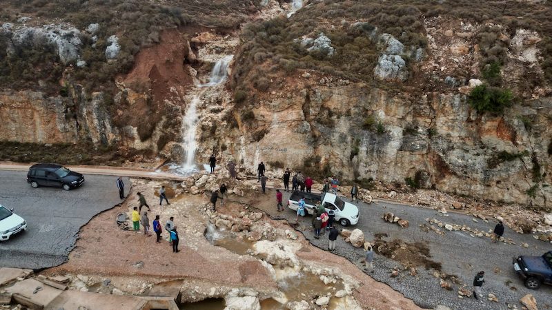 People stuck on a road after a powerful storm and heavy rainfall hit Shahhat city in Libya