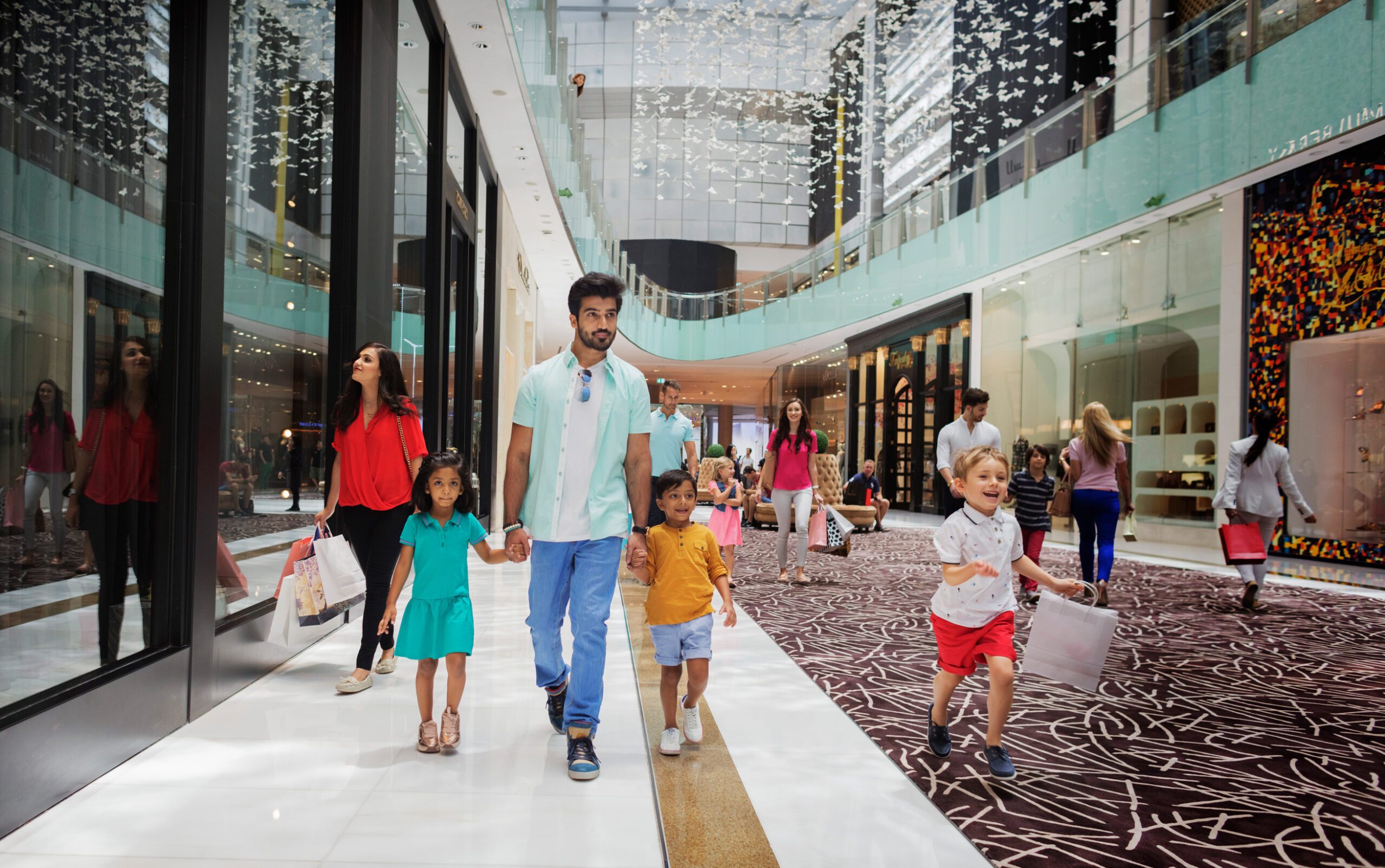 Families at Dubai Mall. The PMI figures on discounts come despite the Summer Surprises shopping festival held in August