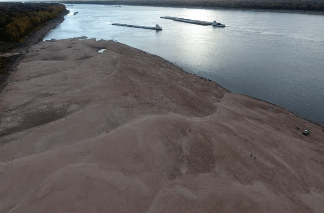 Barges make their way down the Mississippi River, where the water levels have reached historically record lows