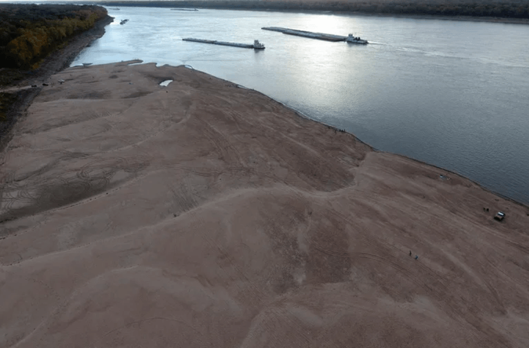 Barges make their way down the Mississippi River, where the water levels have reached historically record lows