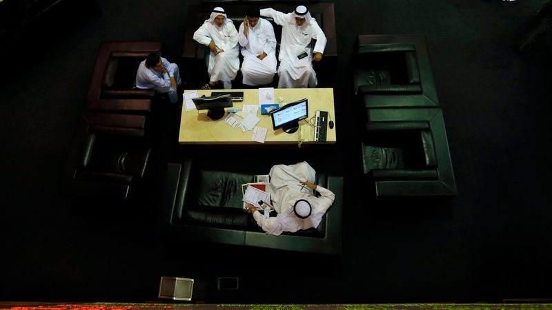 Traders watch screens at the Dubai Financial Market. The rights issue is a step toward repositioning Shuaa for growth, said group CEO Fawad Tariq Khan