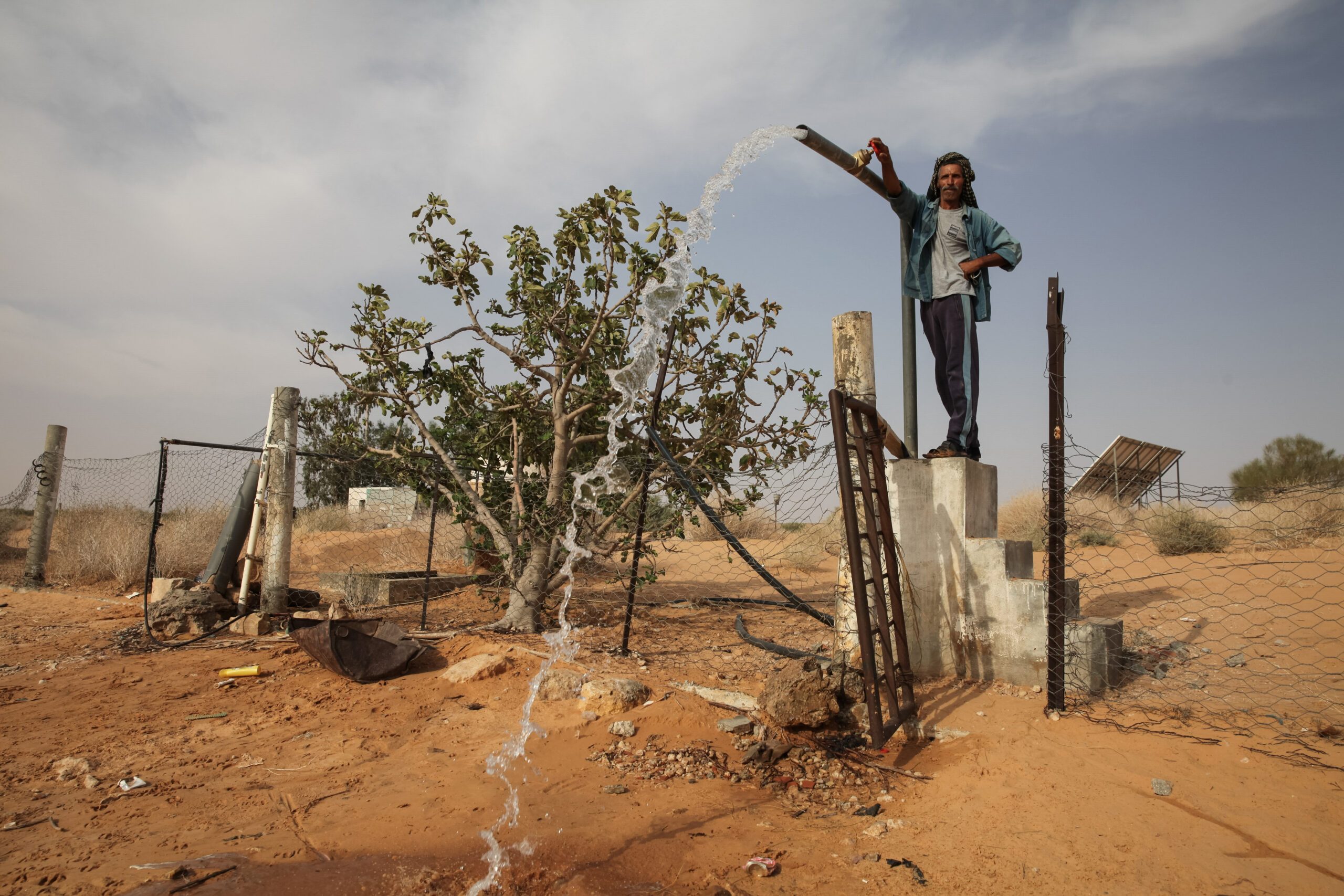 A water vendor in Tunisia opening a well