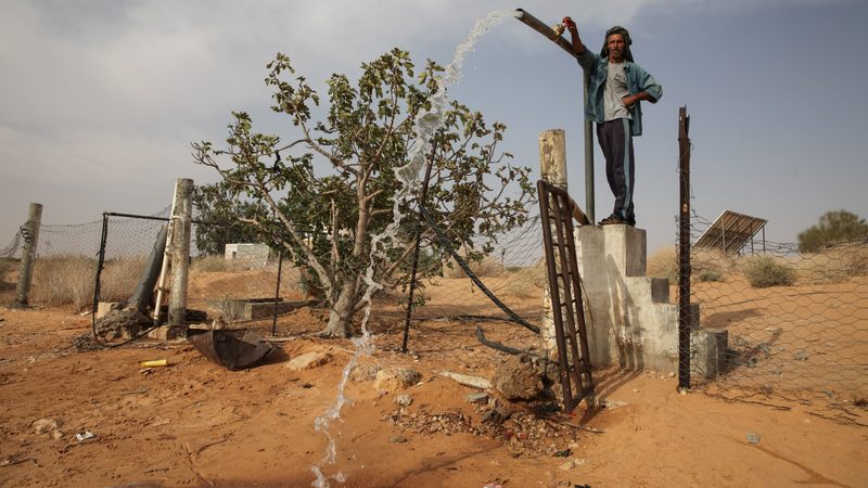 A water vendor in Tunisia opening a well