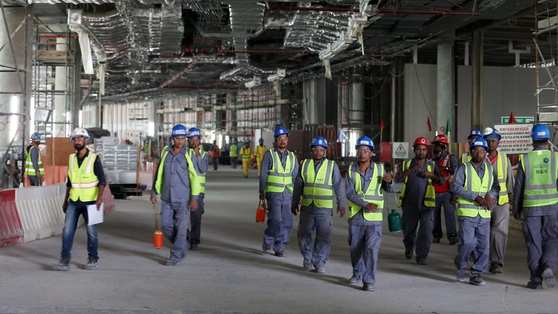 Labourers at Abu Dhabi airport's new terminal, set to open in November. Construction is one of the sectors driving non-oil growth in Q2